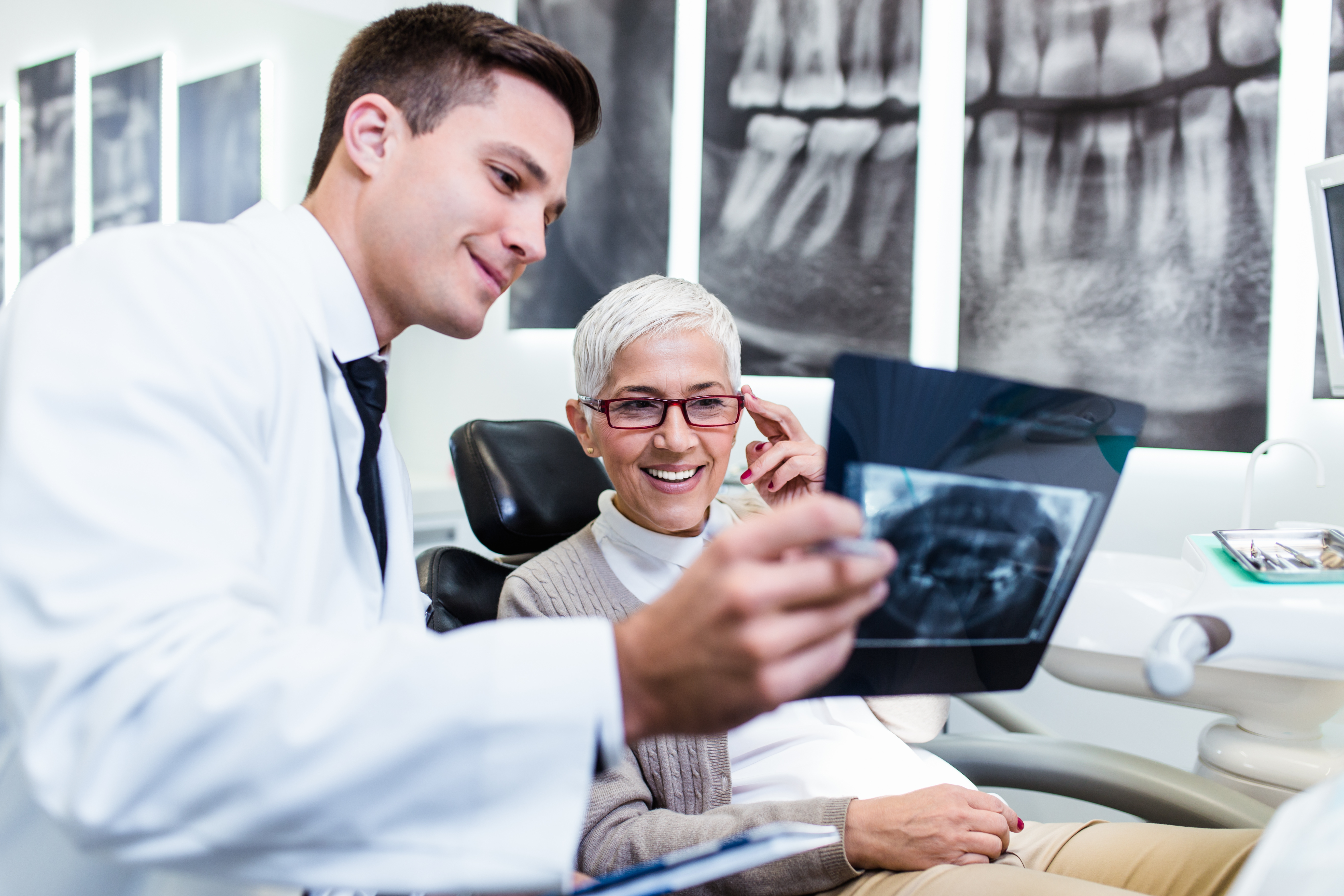 a man looking at an x-ray of a woman